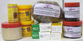 Assorted health and beauty products including jars, boxes, and a bag of dried mixed herbs.