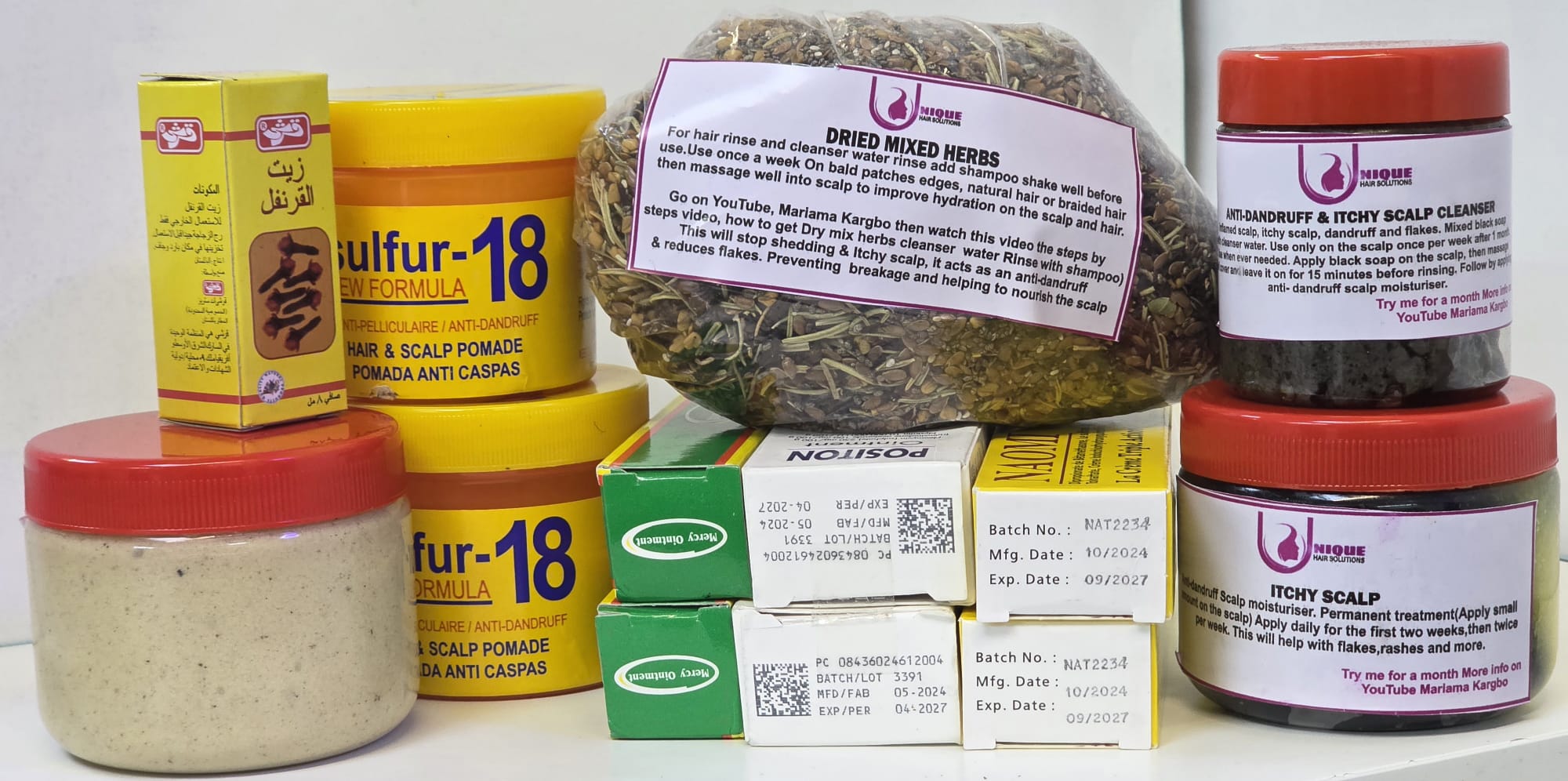 Assorted health and beauty products including jars, boxes, and a bag of dried mixed herbs.